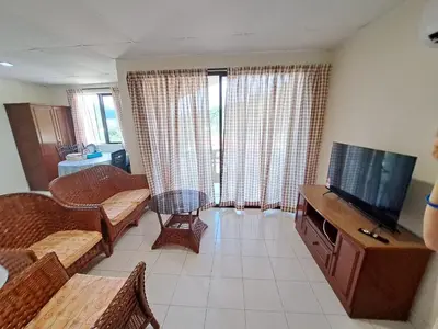 a living room with a flat screen tv and a couch at 311 Pangkor Coral Bay Homestay in Pasir Bogak