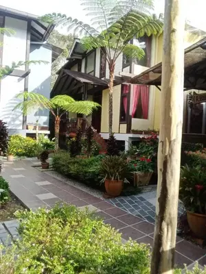 a building with a bunch of plants in front of it at Cahaya Villa in Tanah Rata