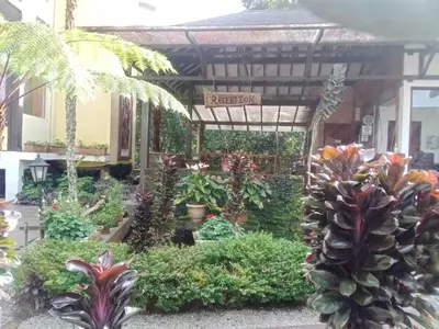 a garden center with a pineapple in the middle at Cahaya Villa in Tanah Rata