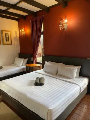 a bedroom with two beds with shoes on the bed at Cahaya Villa in Tanah Rata