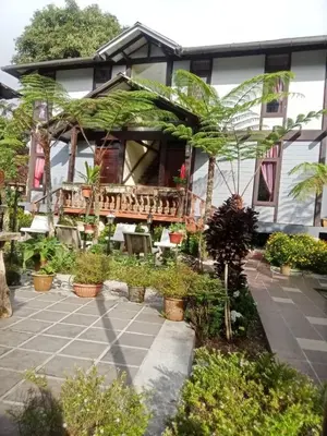 a house with a lot of plants in front of it at Cahaya Villa in Tanah Rata