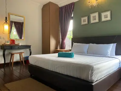 a bedroom with a bed with a blue pillow on it at Cahaya Villa in Tanah Rata