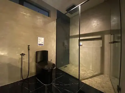 a bathroom with a glass shower and a toilet at SIX Boutique Residence @ Ipoh Garden Landed House 8pax in Ipoh