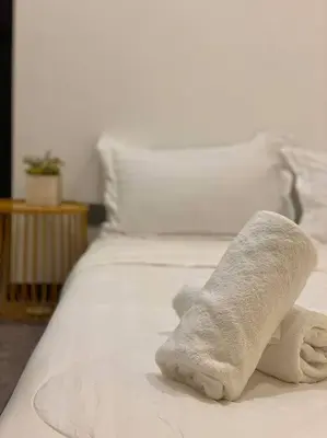 a stuffed animal is sitting on a bed at SIX Boutique Residence @ Ipoh Garden Landed House 8pax in Ipoh