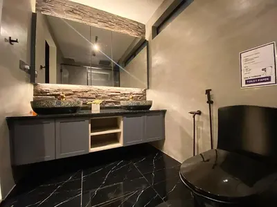 a bathroom with a sink and a toilet and a mirror at SIX Boutique Residence @ Ipoh Garden Landed House 8pax in Ipoh