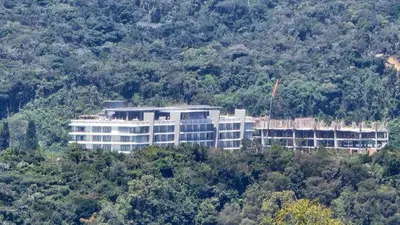 a large white building on top of a hill at The Gladiator Homstay in Brinchang