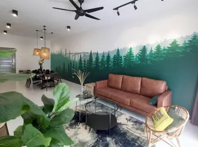a living room with a couch and a painting of trees at ForestNest Cameron Town Spacious 3R3B (1300 sqft) in Tanah Rata