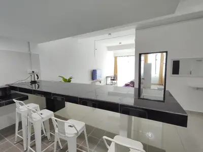 a white kitchen with a mirror and white stools at Homestay Studio Apartment Bentara Suite, Kompleks Mutiara Gua Musang in Gua Musang