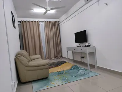 a living room with a chair and a desk at Homestay Studio Apartment Bentara Suite, Kompleks Mutiara Gua Musang in Gua Musang