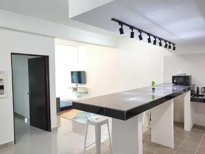 a kitchen with a black counter top in a room at Homestay Studio Apartment Bentara Suite, Kompleks Mutiara Gua Musang in Gua Musang