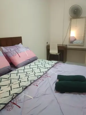 a bedroom with a bed and a desk and a mirror at Sofea Inn Bukit Merah - Laketown A6153 in Kampong Selemat