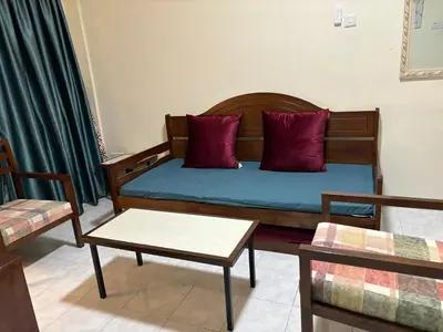 a room with a bed with red pillows and a table at Sofea Inn Bukit Merah - Laketown A6153 in Kampong Selemat