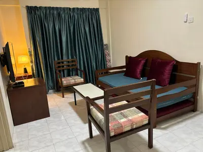a living room with a couch and a chair at Sofea Inn Bukit Merah - Laketown A6153 in Kampong Selemat