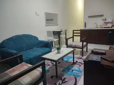 a living room with a couch and a table at Sofea Inn Bukit Merah - Laketown A6153 in Kampong Selemat