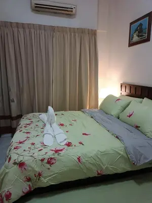 a bed with a stuffed animal sitting on top of it at Sofea Inn Bukit Merah - Laketown A6172 in Kampong Selemat