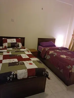 two beds sitting next to each other in a bedroom at Sofea Inn Bukit Merah - Laketown A6172 in Kampong Selemat