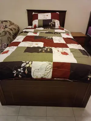 a bed with a quilt on it in a bedroom at Sofea Inn Bukit Merah - Laketown A6172 in Kampong Selemat