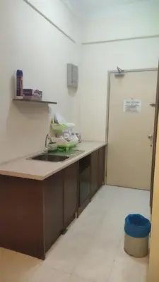 a kitchen with a sink and a refrigerator at Sofea Inn Bukit Merah - Laketown A6172 in Kampong Selemat