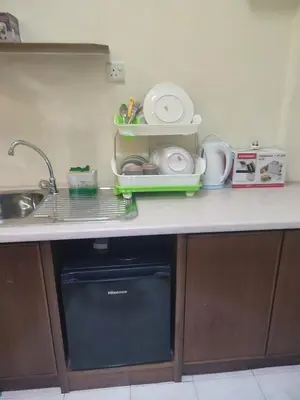 a kitchen counter with a dish drying rack and a microwave at Sofea Inn Bukit Merah - Laketown A6172 in Kampong Selemat