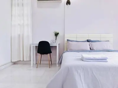 a bedroom with a bed and a desk and a chair at Family 4BR Landed House @ SPICE ARENA in Bayan Lepas