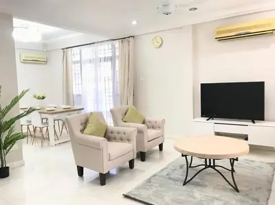 a living room with two chairs and a flat screen tv at Family 4BR Landed House @ SPICE ARENA in Bayan Lepas