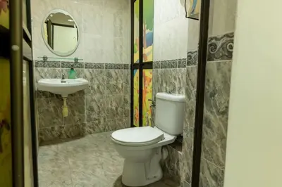 a bathroom with a toilet and a sink at Family 4BR Landed House @ SPICE ARENA in Bayan Lepas
