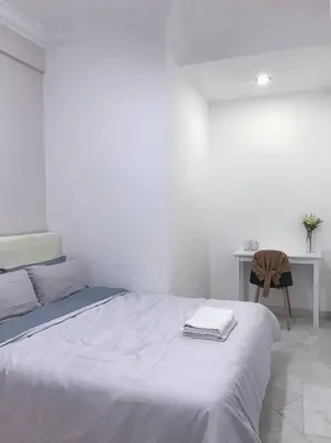 a white bedroom with a bed and a desk at Family 4BR Landed House @ SPICE ARENA in Bayan Lepas