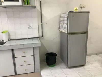 a kitchen with a refrigerator in the corner at 4 Bedrooms Ipoh Landed House, Ipoh Town in Ipoh