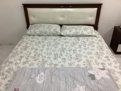 a bed with a blanket and pillows on it at 4 Bedrooms Ipoh Landed House, Ipoh Town in Ipoh