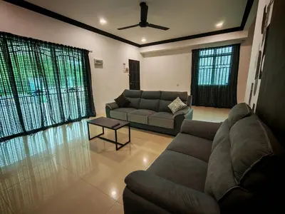 a living room with a couch and a table at Air-home M1 Simpang near Aulong Econsave, 4BR, 10pax, Netflix in Simpang