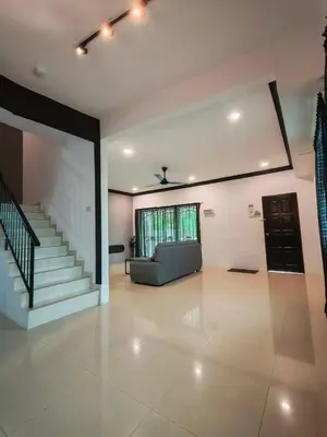 an empty living room with a couch and stairs at Air-home M1 Simpang near Aulong Econsave, 4BR, 10pax, Netflix in Simpang
