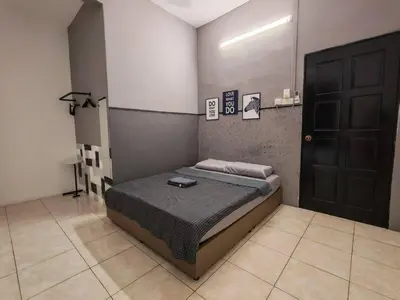 a bedroom with a bed and a black door at Air-home M1 Simpang near Aulong Econsave, 4BR, 10pax, Netflix in Simpang