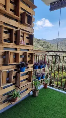 a wooden wall with potted plants on a balcony at Emerald Avenue Cozy 3R3B Apartment 830 in Brinchang