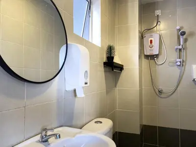 a bathroom with a shower and a sink and a mirror at Emerald Avenue Cozy 3R3B Apartment 830 in Brinchang