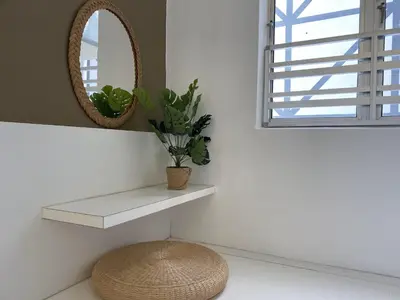 a bathroom with a shelf and a mirror and a stool at Emerald Avenue Cozy 3R3B Apartment 830 in Brinchang