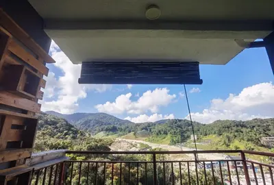 a room with a balcony with a view of the mountains at Emerald Avenue Cozy 3R3B Apartment 830 in Brinchang