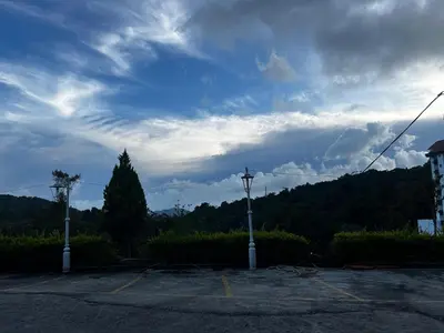 a street light in a parking lot under a cloudy sky at Tekoma Hotel & Hostel Cameron Highlands - FREE SHUTTLE SERVICE in Tanah Rata