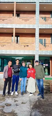 a group of people standing in front of a building at Tekoma Hotel & Hostel Cameron Highlands - FREE SHUTTLE SERVICE in Tanah Rata
