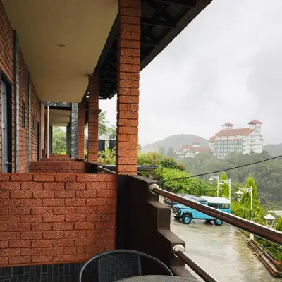 a balcony of a building with a view of a city at Tekoma Hotel & Hostel Cameron Highlands - FREE SHUTTLE SERVICE in Tanah Rata