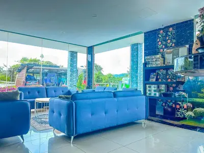 a blue room with blue chairs and a table at Tekoma Hotel & Hostel Cameron Highlands - FREE SHUTTLE SERVICE in Tanah Rata
