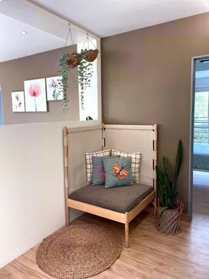 a bench with pillows on it in a room at Emerald Avenue Cozy 3R3B Apartment 822 in Brinchang