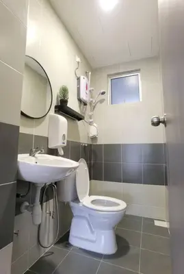 a bathroom with a white toilet and a sink at Emerald Avenue Cozy 3R3B Apartment 822 in Brinchang