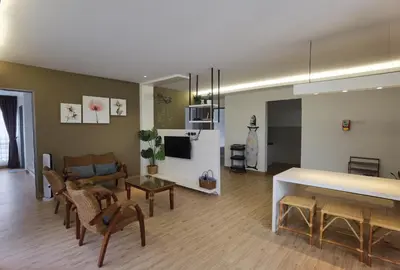 a living room with a couch and a table at Emerald Avenue Cozy 3R3B Apartment 822 in Brinchang