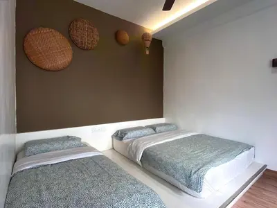 a bedroom with two beds and two baskets on the wall at Emerald Avenue Cozy 3R3B Apartment 822 in Brinchang