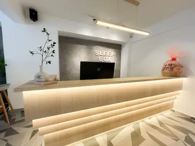 a selvesbury counter in a store with a vase at Sleep Box Penang in George Town