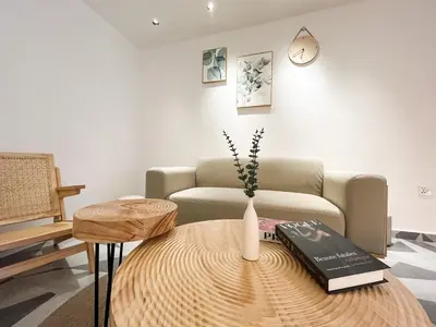 a living room with a couch and a table with books at Sleep Box Penang in George Town