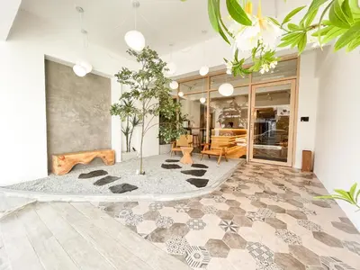 a lobby with a table and chairs in a building at Sleep Box Penang in George Town