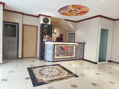 a man standing in a room with a rug on the floor at Capital O 90897 Island City Hotel in George Town