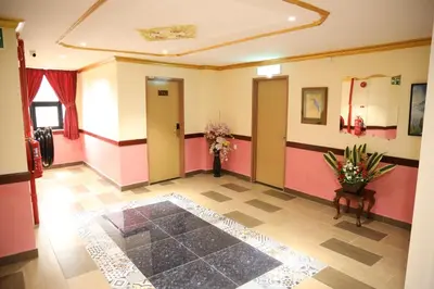 a hallway with a room with flowers on the floor at Capital O 90897 Island City Hotel in George Town