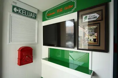 a shop with a red fire hydrant on a wall at Shamrock Guest House in Ipoh
